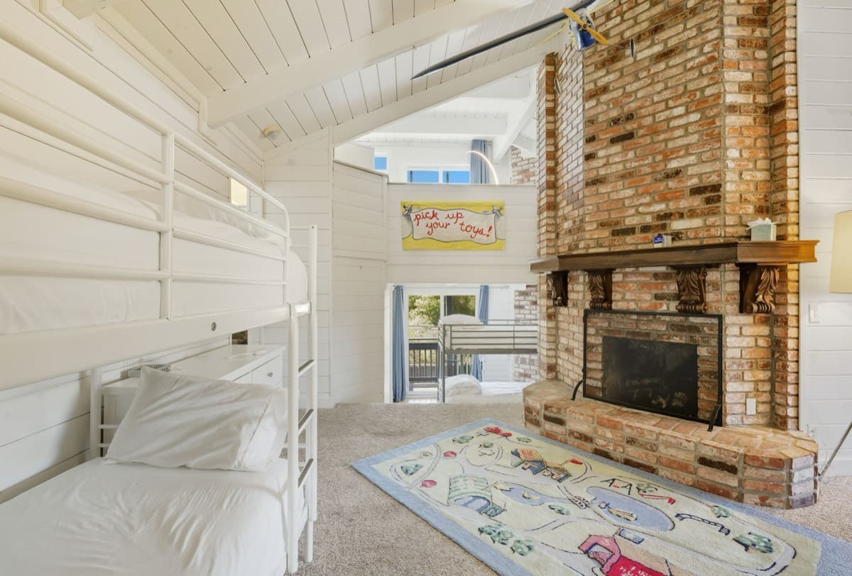 The bunk room with brick fireplace